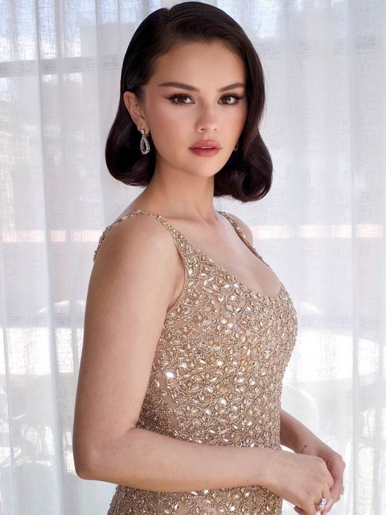 close up of Selena Gomez wears a custom Oscar de la Renta champagne crystal-embroidered gown at Taylor Swift and Travis Kelce's wedding.