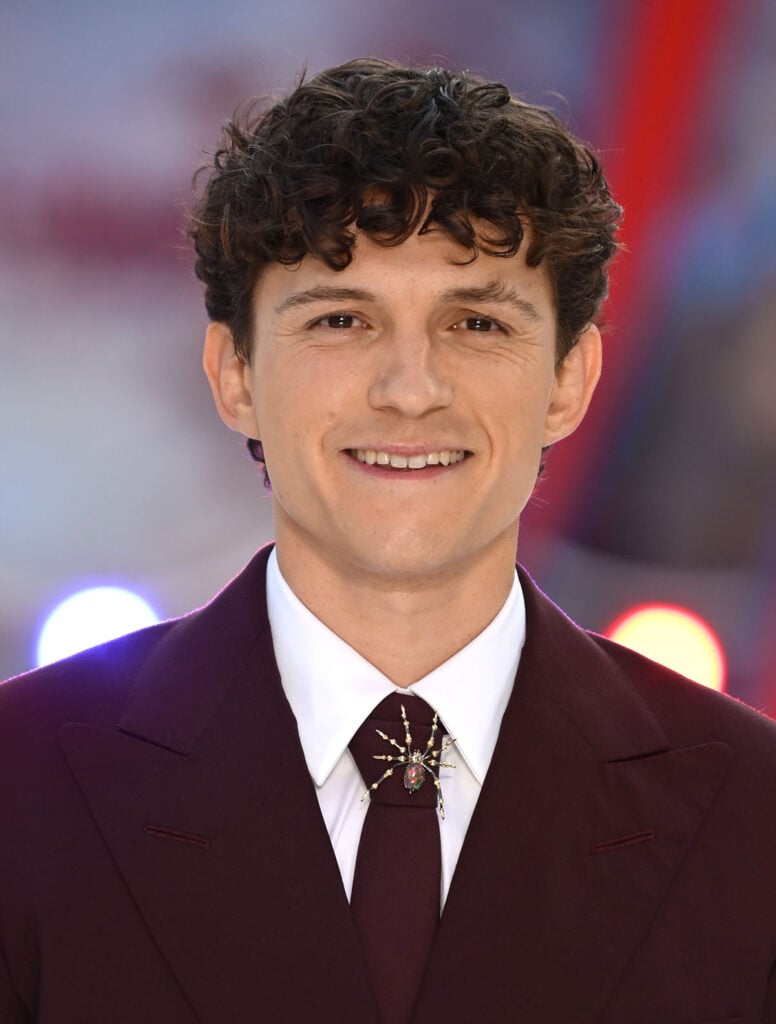 Close-up of Tom Holland's one-of-a-kind Pragnell spider brooch pinned to his tie at the Spider-Man: Brand New Day premiere.