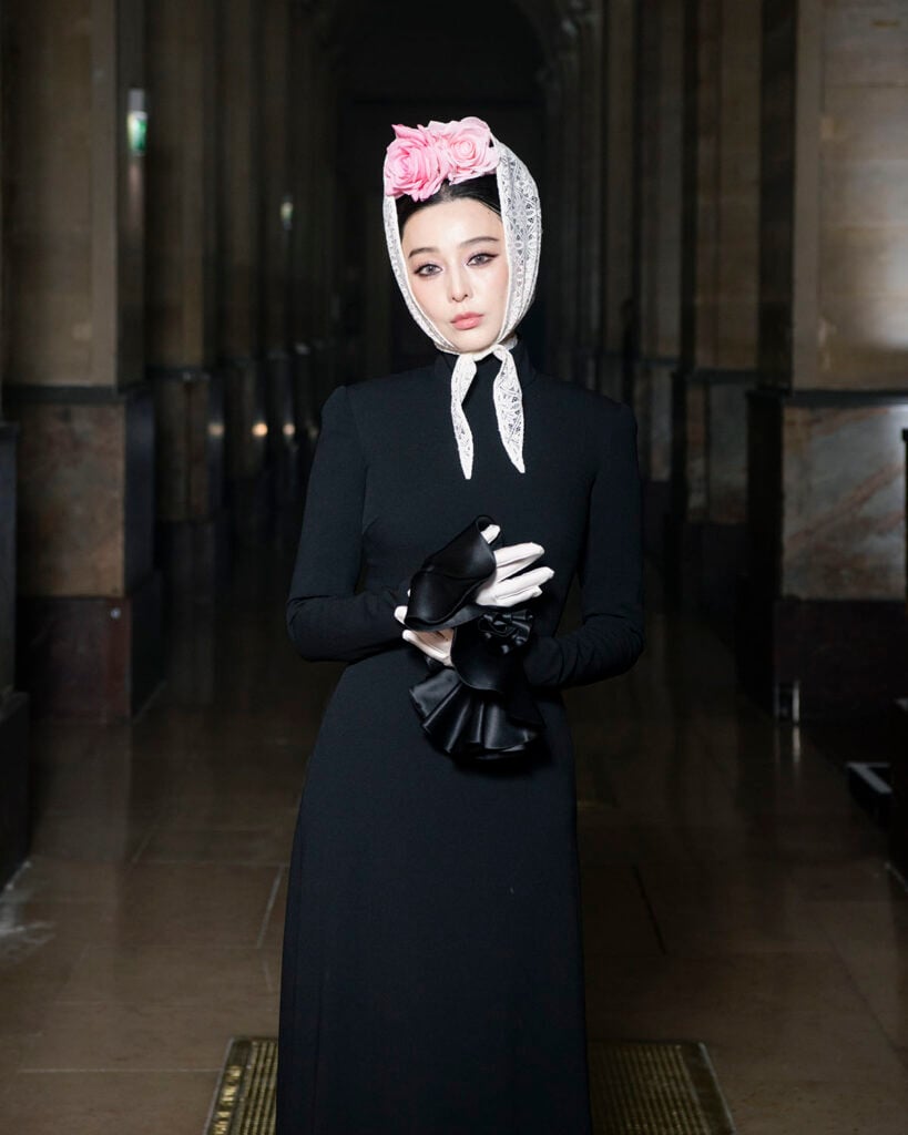 Close-up of Fan Bingbing wearing Viktor & Rolf Fall 2026 Couture with floral lace-trimmed bonnet.