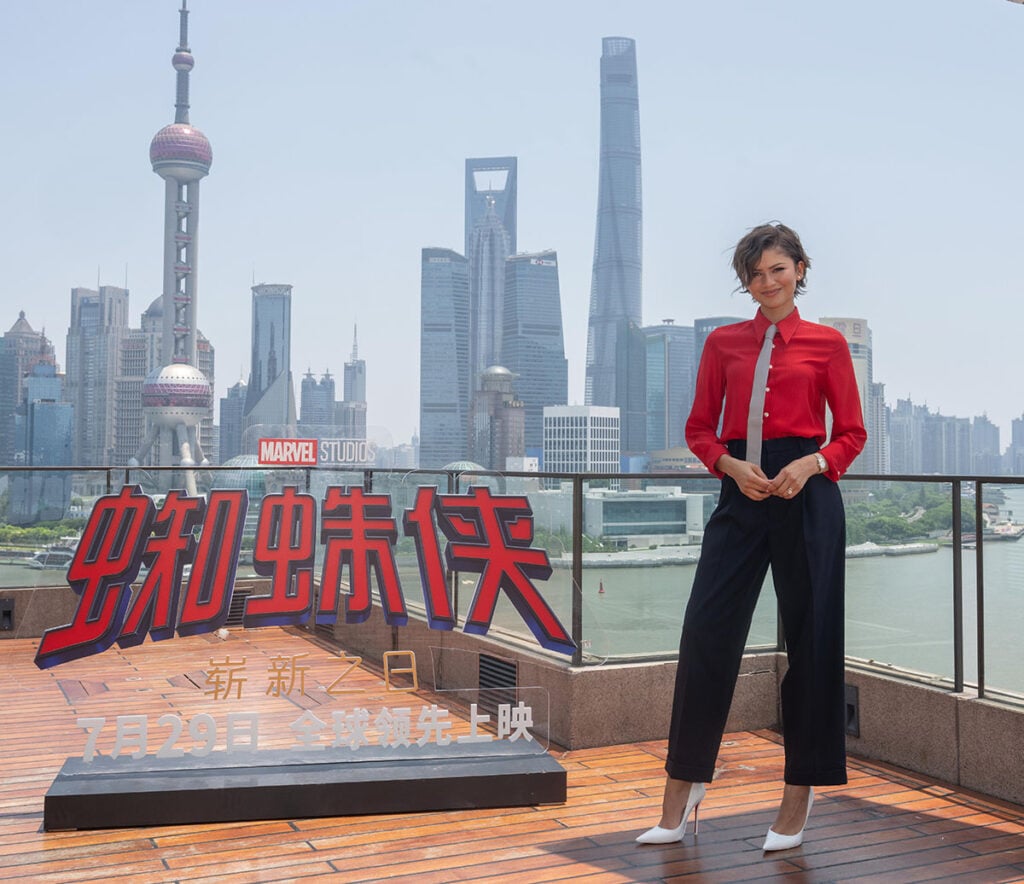 Zendaya posing in Coach Resort 2027 with white Christian Louboutin Miss Z pumps in Shanghai.