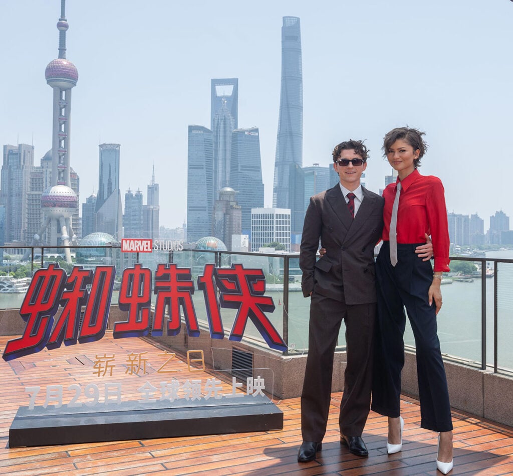 Zendaya and Tom Holland attending the Spider-Man: Brand New Day Shanghai photocall in coordinated Coach and Prada looks.
