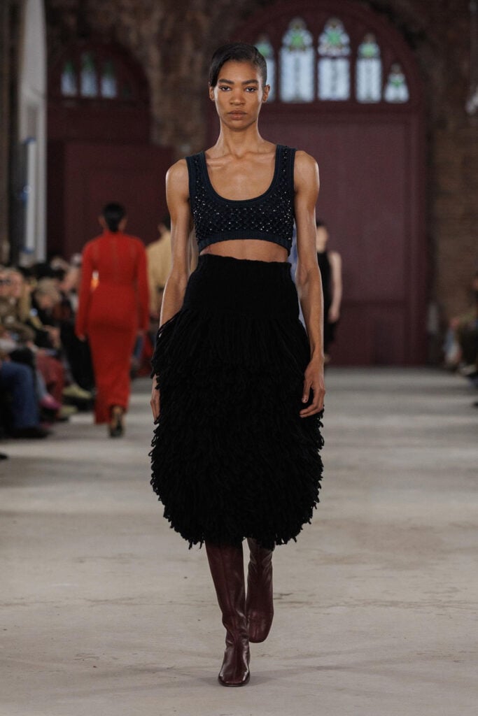 Diotima Fall 2026 black fringed crochet crop top and skirt on the runway.