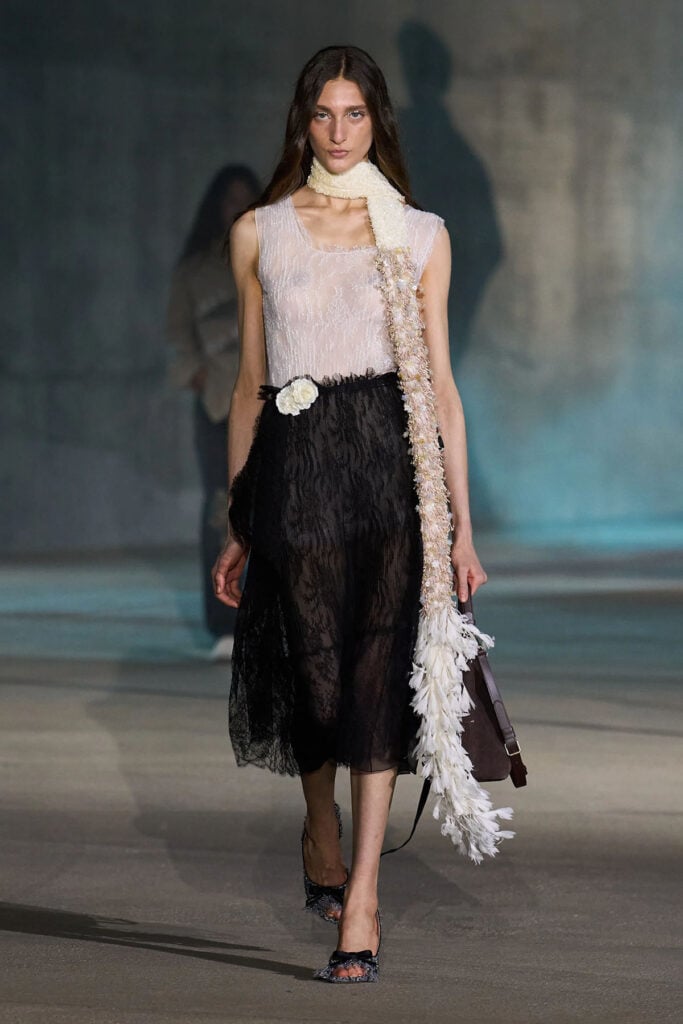 Dior Resort 2027 runway look featuring the white lace top and black lace skirt.
