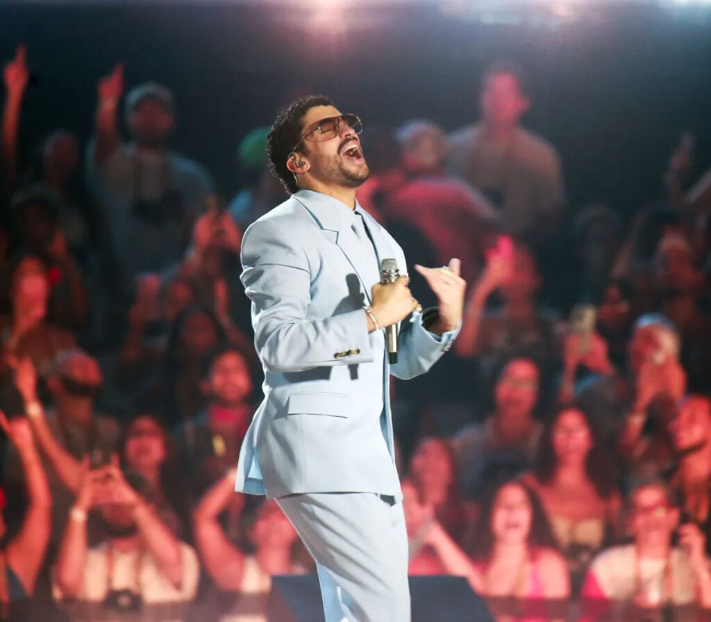 Bad Bunny performing in a Saint Laurent blue suit during his DeBÍ TiRAR MáS FOToS World Tour finale in San Juan, Puerto Rico.