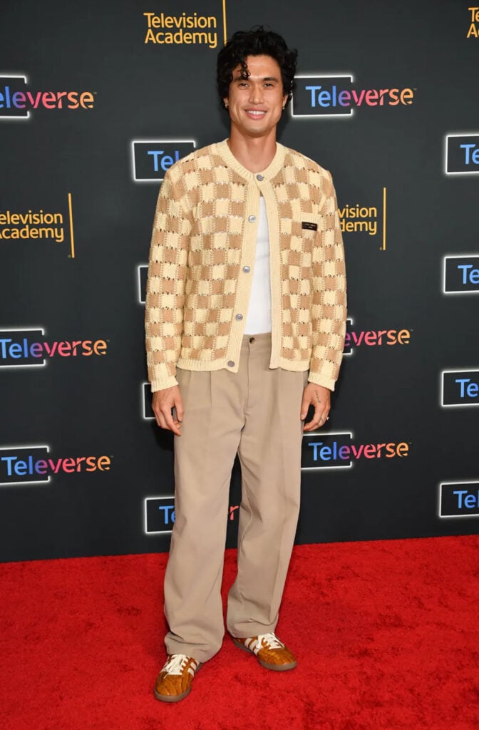 Charles Melton wearing a Louis Vuitton checked cardigan and relaxed trousers at Televerse 26.