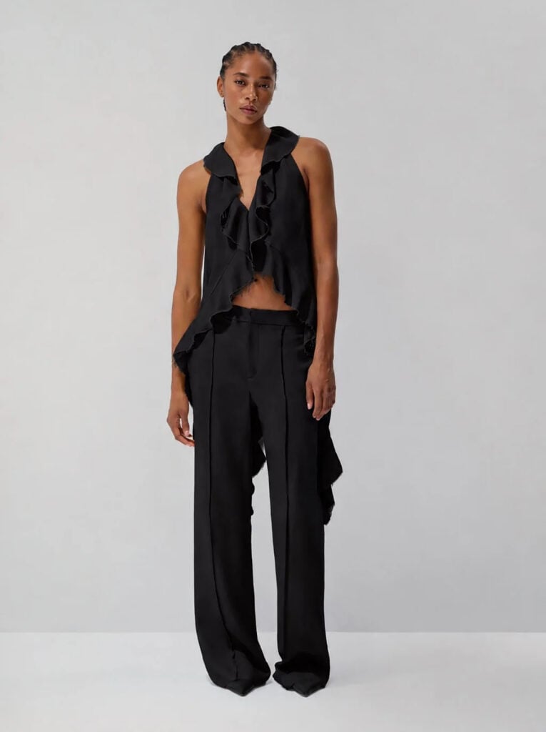 LEIN Alexandra ruffled top and Banks trousers shown in the label’s black lookbook styling