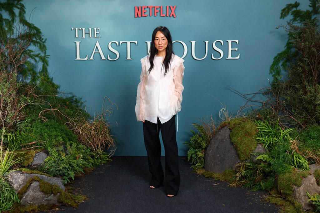 Greta Lee wears The Row shirt and black trousers Resort 2027 at the 'The Last House' photocall at The Soho Hotel in London.