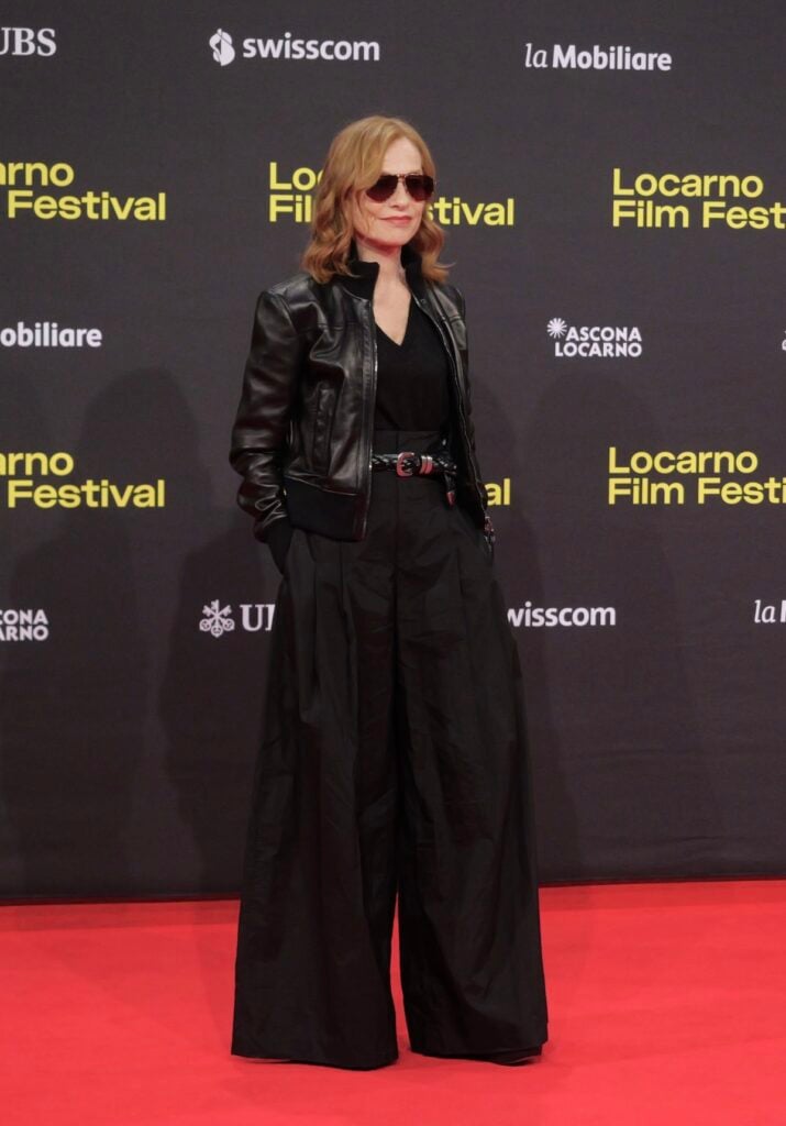 Isabelle Huppert wears a Brunello Cucinelli leather jacket and wide-leg trousers at the 'Ni vue, ni connue' premiere in Locarno.