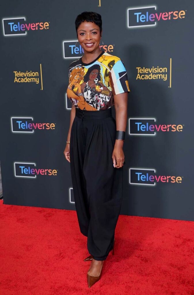 Janelle James wearing a Mickalene Thomas art T-shirt with black trousers at Televerse 26.