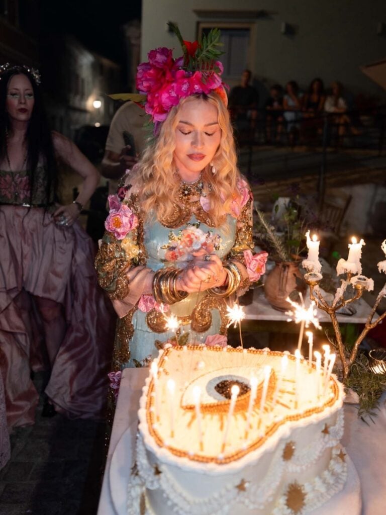 Madonna pairs her embellished Dolce & Gabbana Alta Moda dress with Alta Gioielleria floral jewellery and gold accessories.