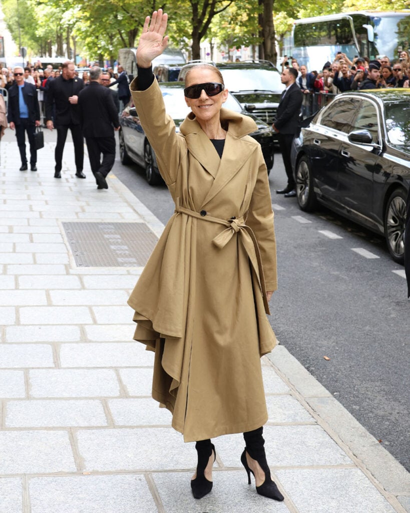 Céline Dion wears an asymmetric Alaïa wrap coat with thigh-high suede boots while arriving in Paris.