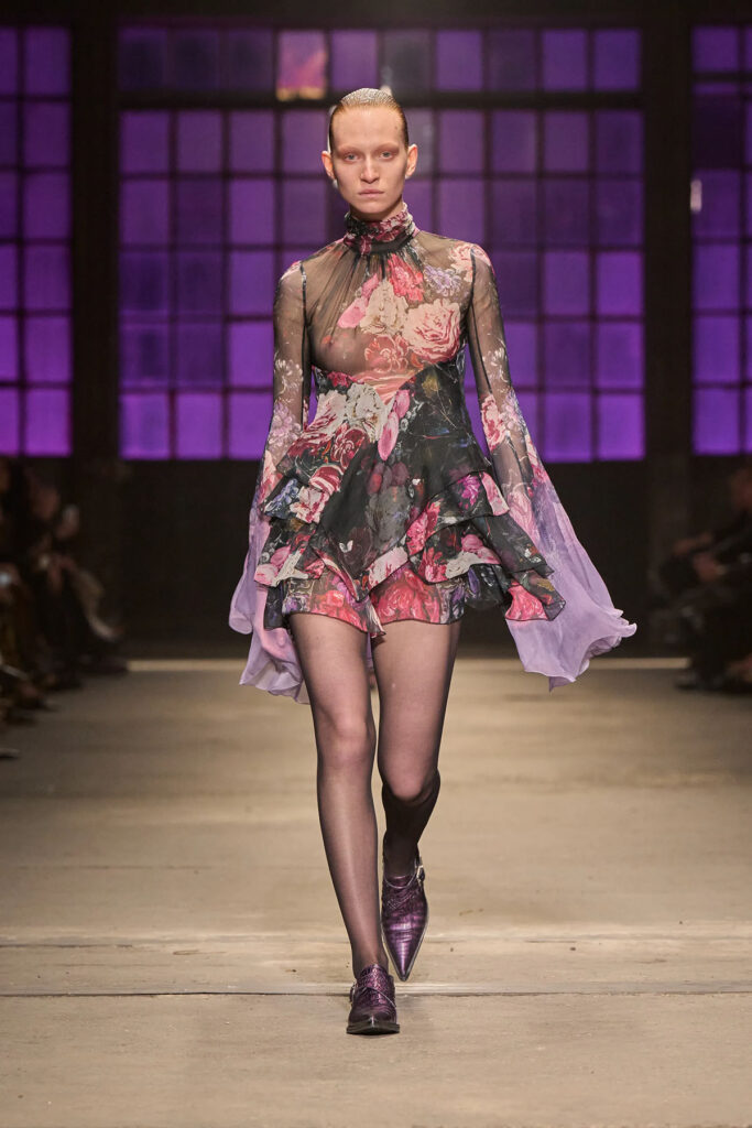 A model wears the sheer floral Roberto Cavalli Fall 2026 mini dress later seen on Joey King during the Practical Magic 2 London press tour.