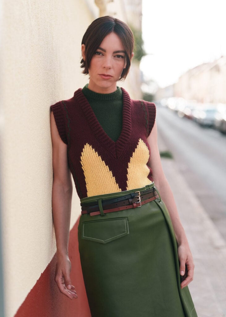 Victoria Luengo in a burgundy, yellow and green Marni look with three leather belts in Madrid