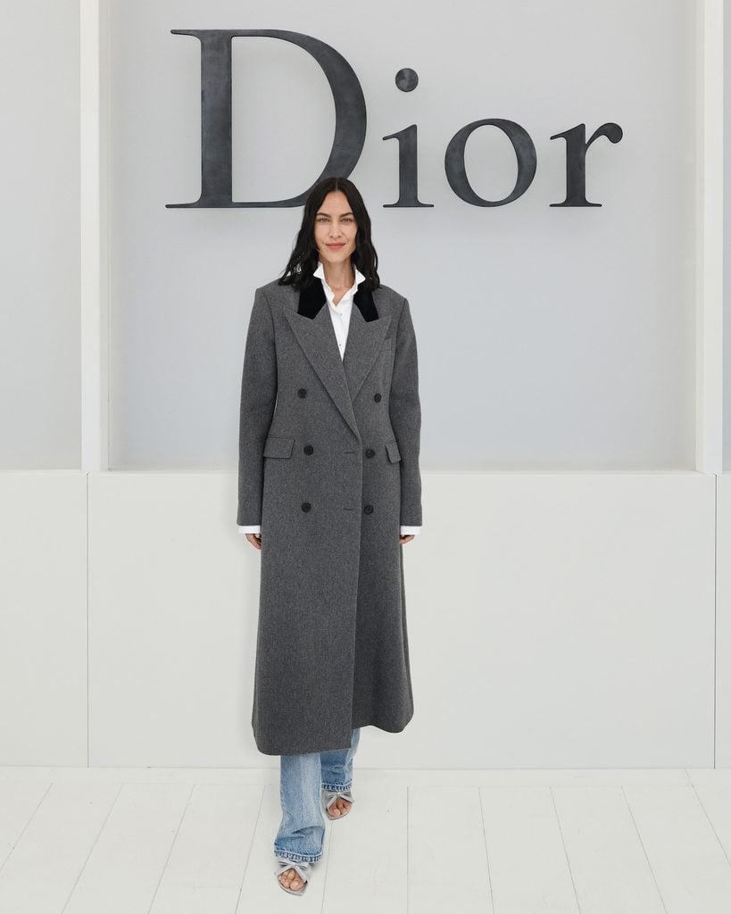 Alexa Chung wearing a grey Dior coat at the Dior Spring 2027 show in Paris.