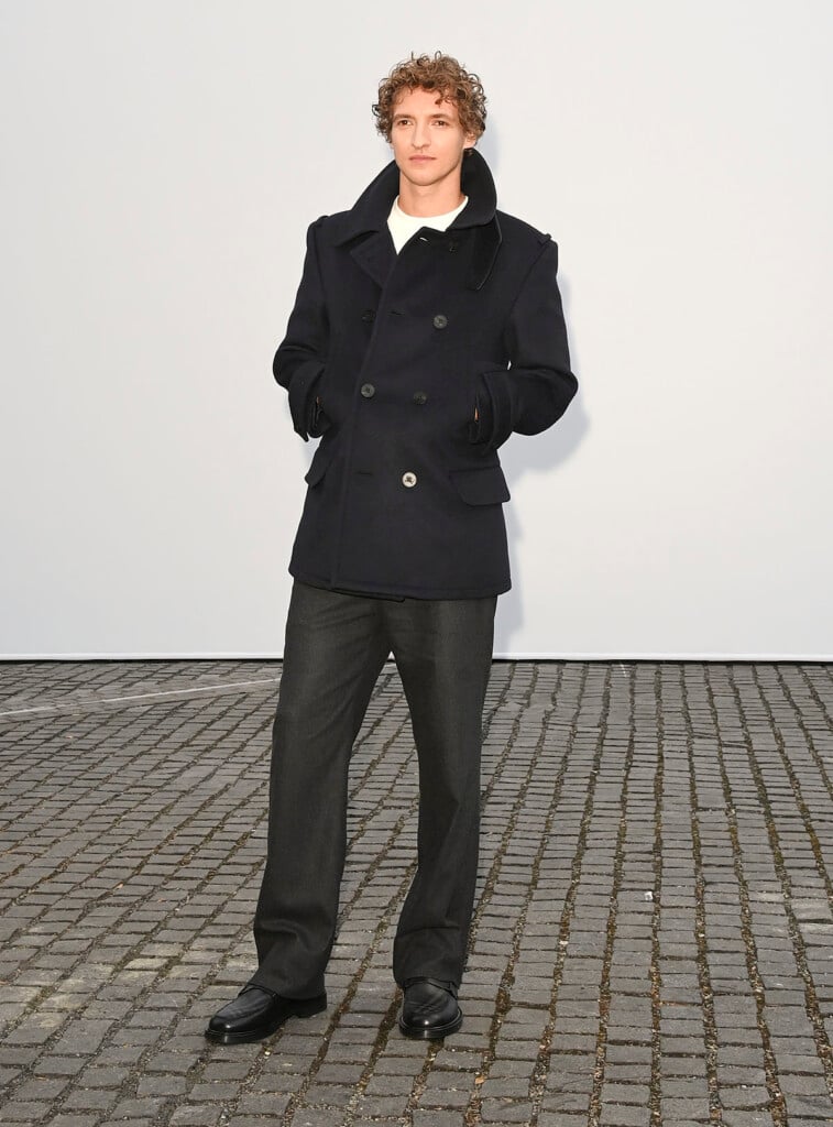 Aliocha Schneider wearing a brown double-breasted Burberry wool coat at the Burberry Summer 2027 show in London