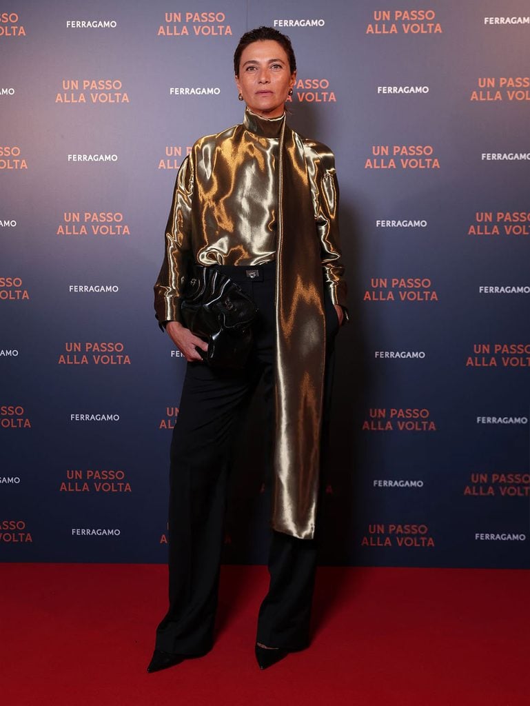 Anna Foglietta wearing a liquid-gold Ferragamo top with black trousers at the Un Passo Alla Volta screening in Venice.