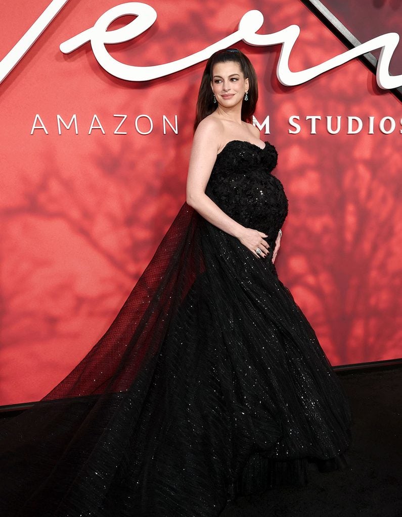 Anne Hathaway wears a fitted black Atelier Prabal Gurung gown showcasing her baby bump at the ‘Verity’ New York premiere.