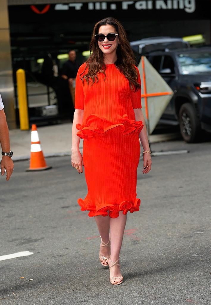 Anne Hathaway wearing red Carolina Herrera during the Verity press tour.
