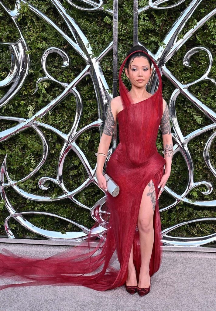 Bella Poarch wearing a red Do Long gown with a sculpted hooded neckline at the Lucas Museum Opening Night.