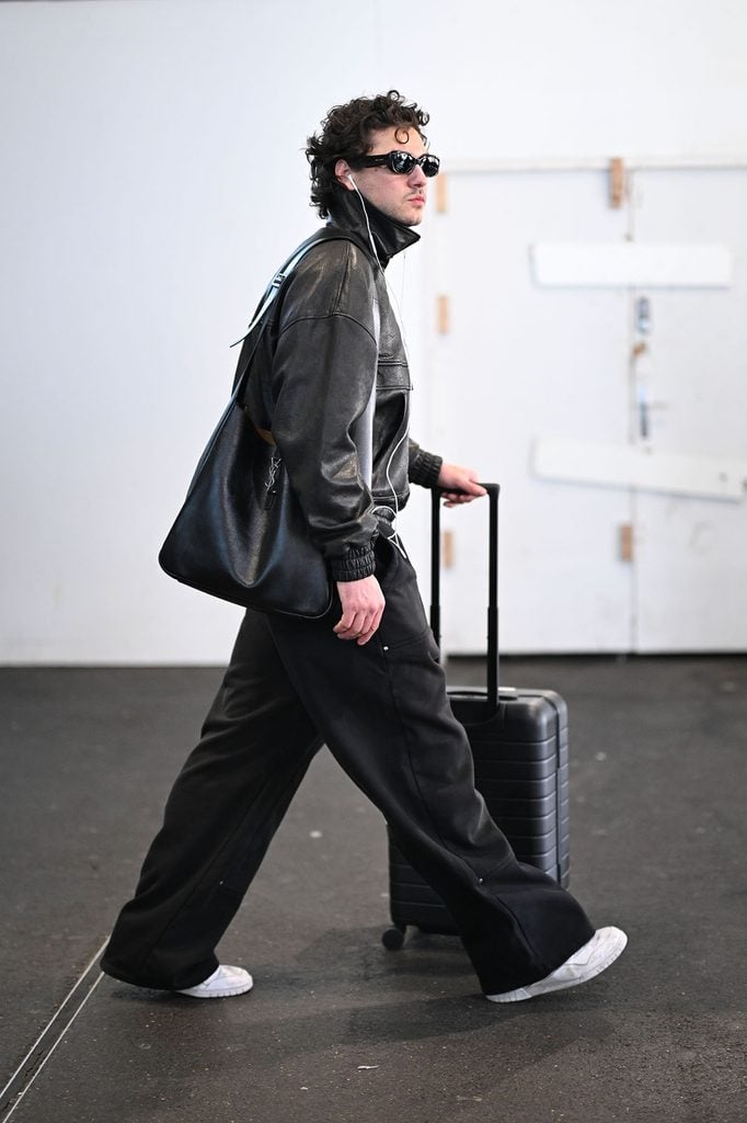 Belmont Cameli wears a Saint Laurent leather bomber jacket with the Le 5 à 7 Maxi hobo bag while arriving in Paris.