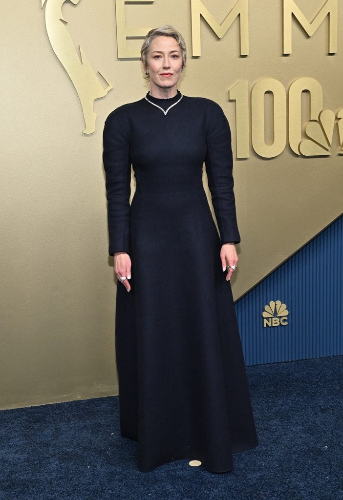 Carrie Coon wearing a navy Maison Margiela gown with rounded shoulders at the 2026 Emmy Awards.