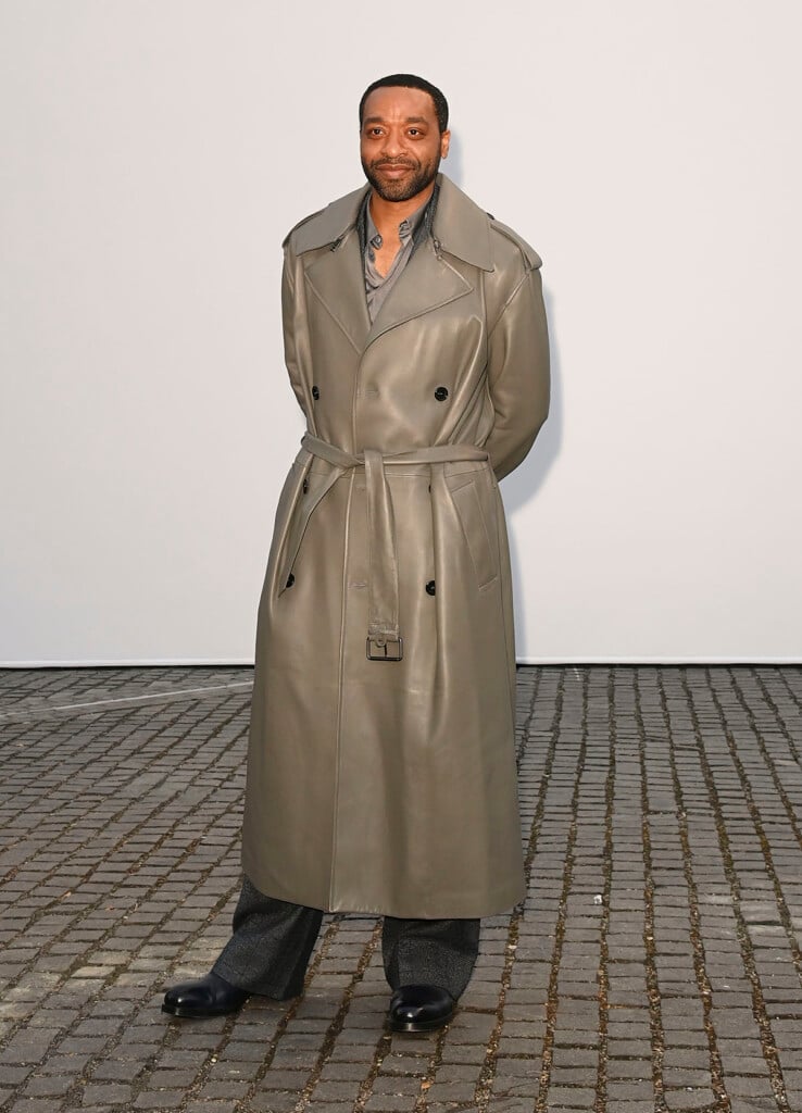 Chiwetel Ejiofor wearing a taupe leather Burberry trench coat at the Burberry Summer 2027 show in London