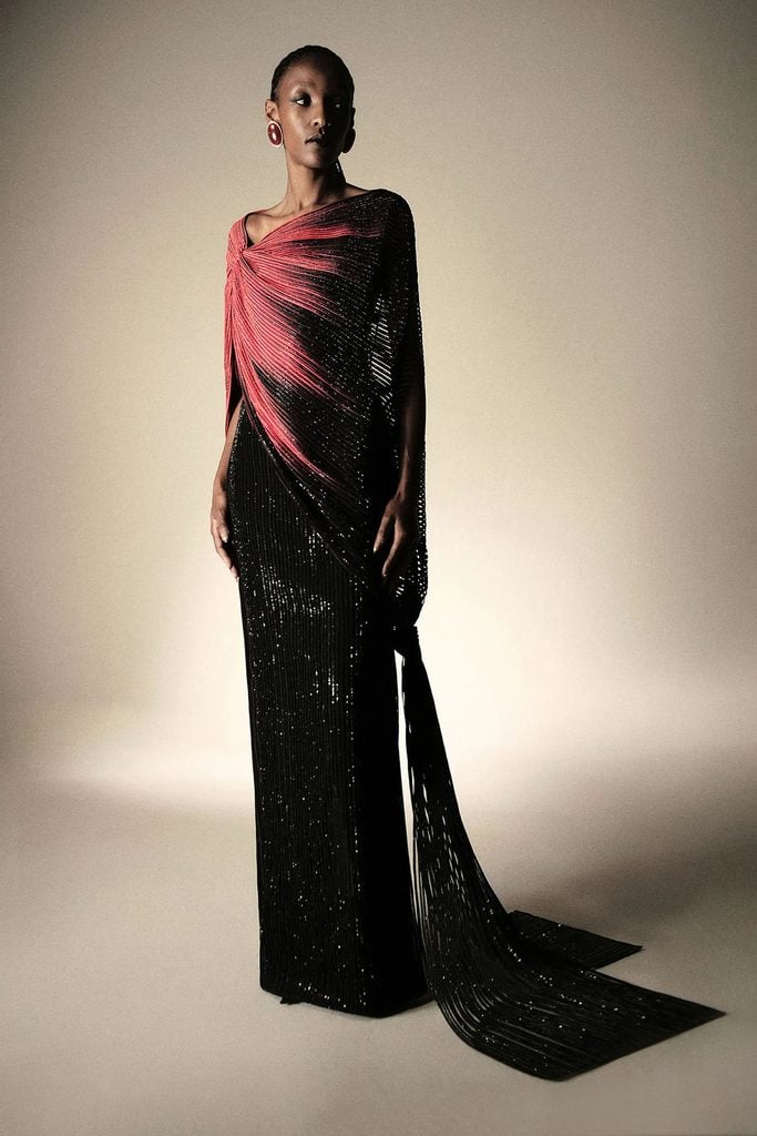 Cong Tri Fall 2026 red-and-black pleated asymmetric gown shown in the collection lookbook.