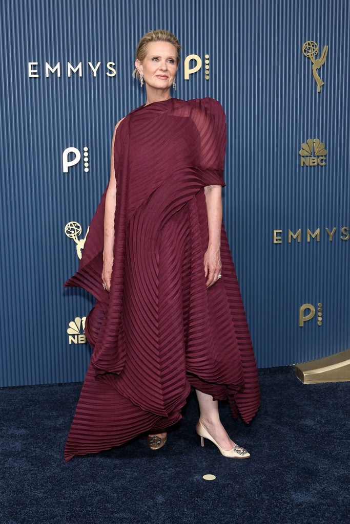 Cynthia Nixon in an asymmetric Issey Miyake dress with pleated panels on the 2026 Emmys red carpet.