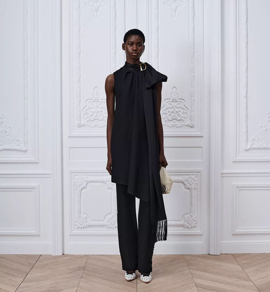 Dior runway look featuring the black draped dress layered over trousers.