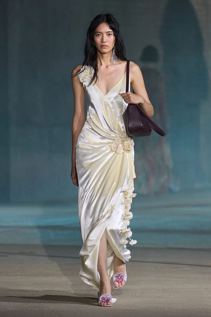 Dior Resort 2027 ivory draped dress with floral appliqués on the runway.