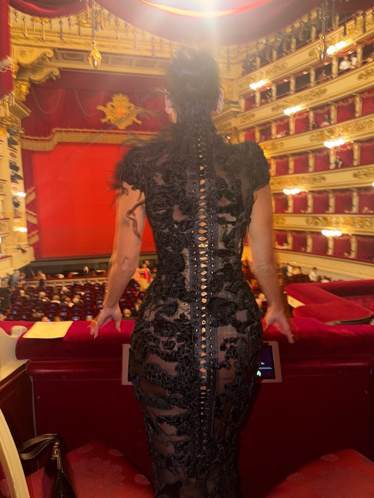 Dua Lipa seen from behind in her black Ashi Studio Couture gown, revealing the full-length lace-up back at La Scala.