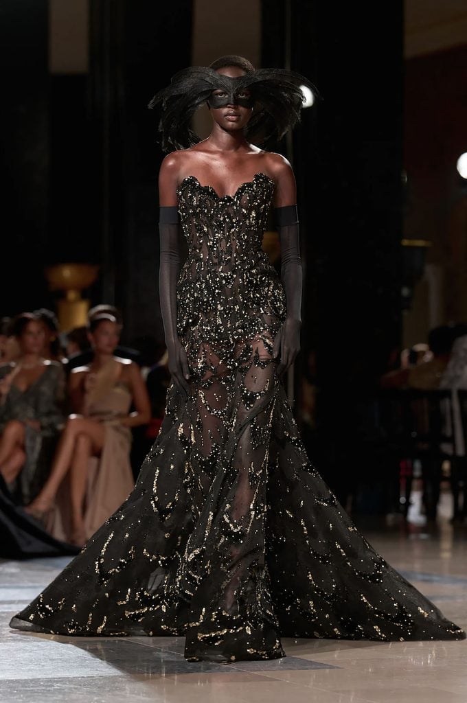 Elie Saab Fall 2026 Haute Couture black and gold embellished gown on the runway.