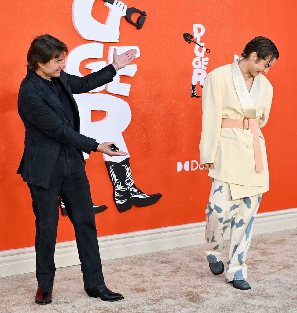 Tom Cruise reacts to Emma D’Arcy’s Dries Van Noten look on the red carpet at the ‘Digger’ Los Angeles premiere.
