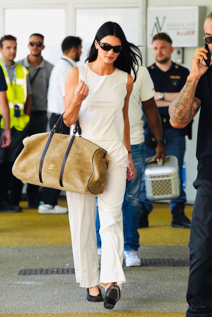 Kendall Jenner carrying a suede Chanel Resort 2027 Weekender bag on arrival in Venice for the 2026 Venice Film Festival.