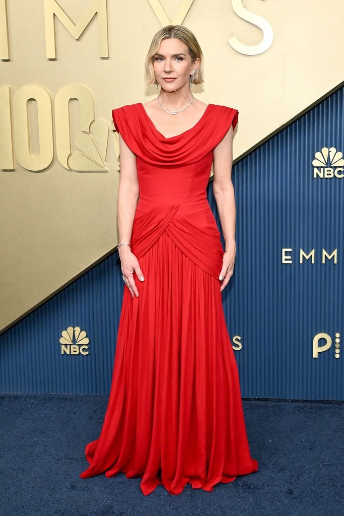 Rhea Seehorn wearing a custom red silk draped Louis Vuitton gown on the 2026 Emmy Awards red carpet.