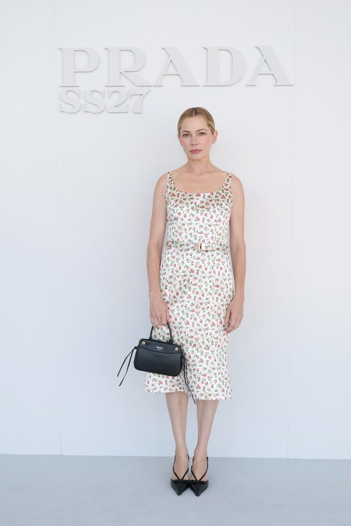 Michelle Williams wearing a floral Prada dress at the Spring/Summer 2027 womenswear show in Milan.