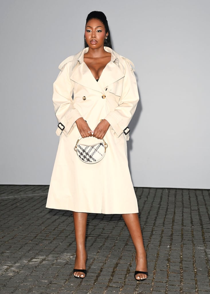 Ms Banks wearing a stone Burberry trench coat at the Burberry Summer 2027 show in London