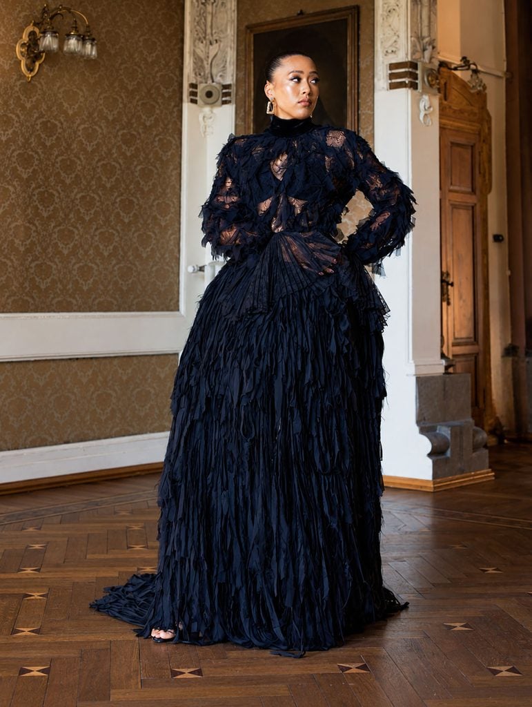 Naomi Osaka wearing a black Roberto Cavalli lace blouse and voluminous chiffon skirt at Vogue World Milano