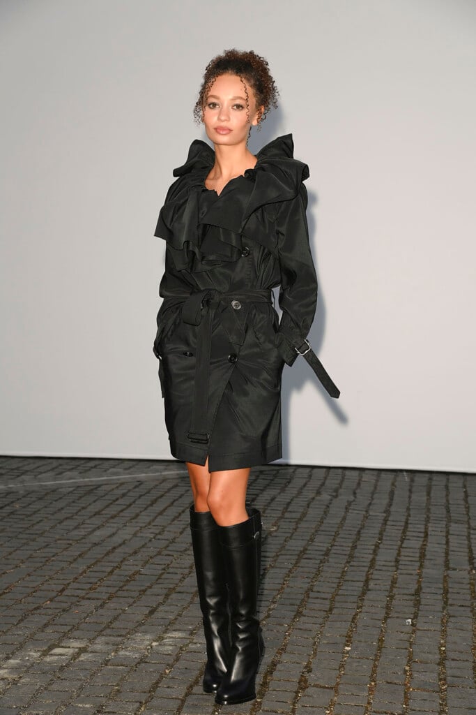 Nico Parker wearing a black Burberry trench coat with oversized ruffled detailing at the Burberry Summer 2027 show in London