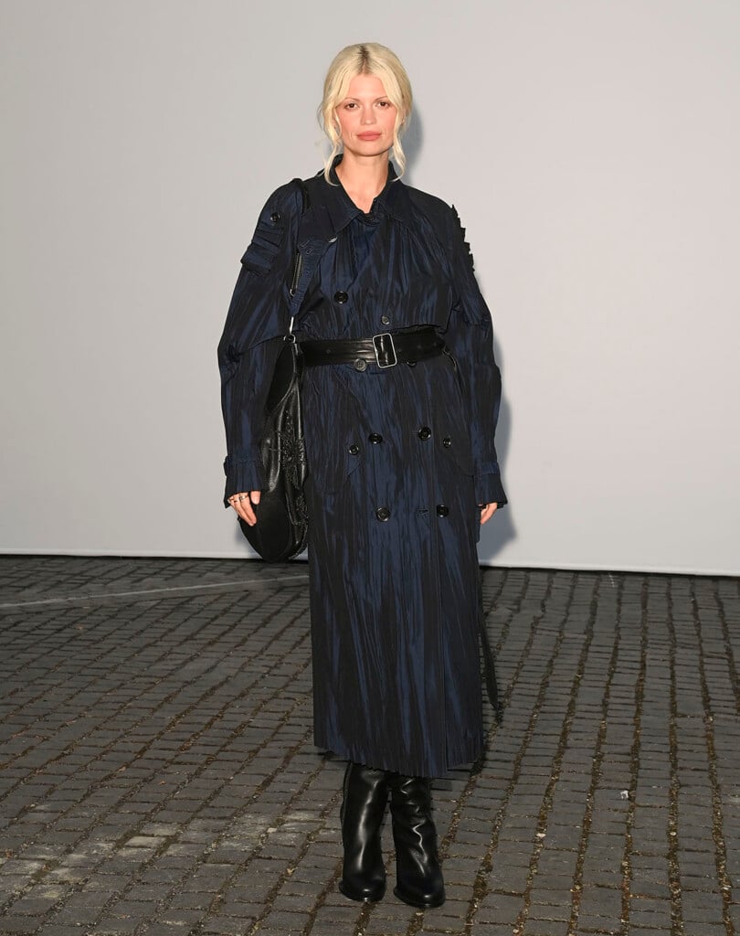 Pixie Geldof wearing a textured navy Burberry trench coat at the Burberry Summer 2027 show in London