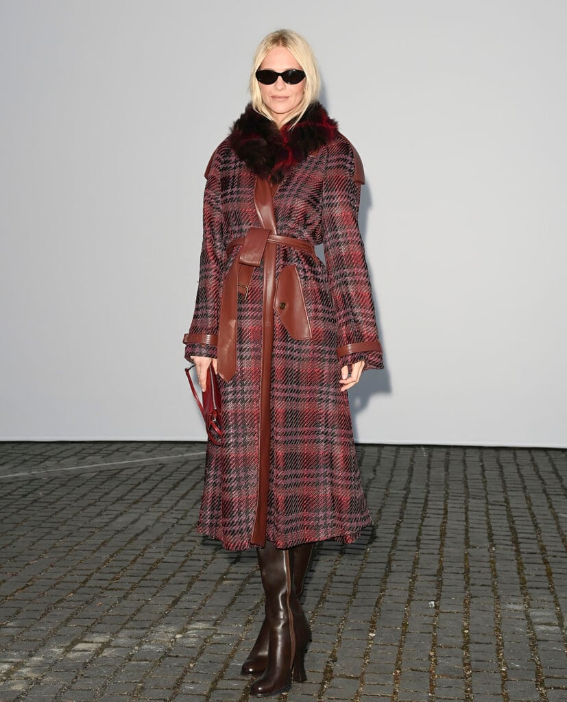 Poppy Delevingne wearing a checked Burberry coat with leather trims and a fur collar at the Summer 2027 show in London