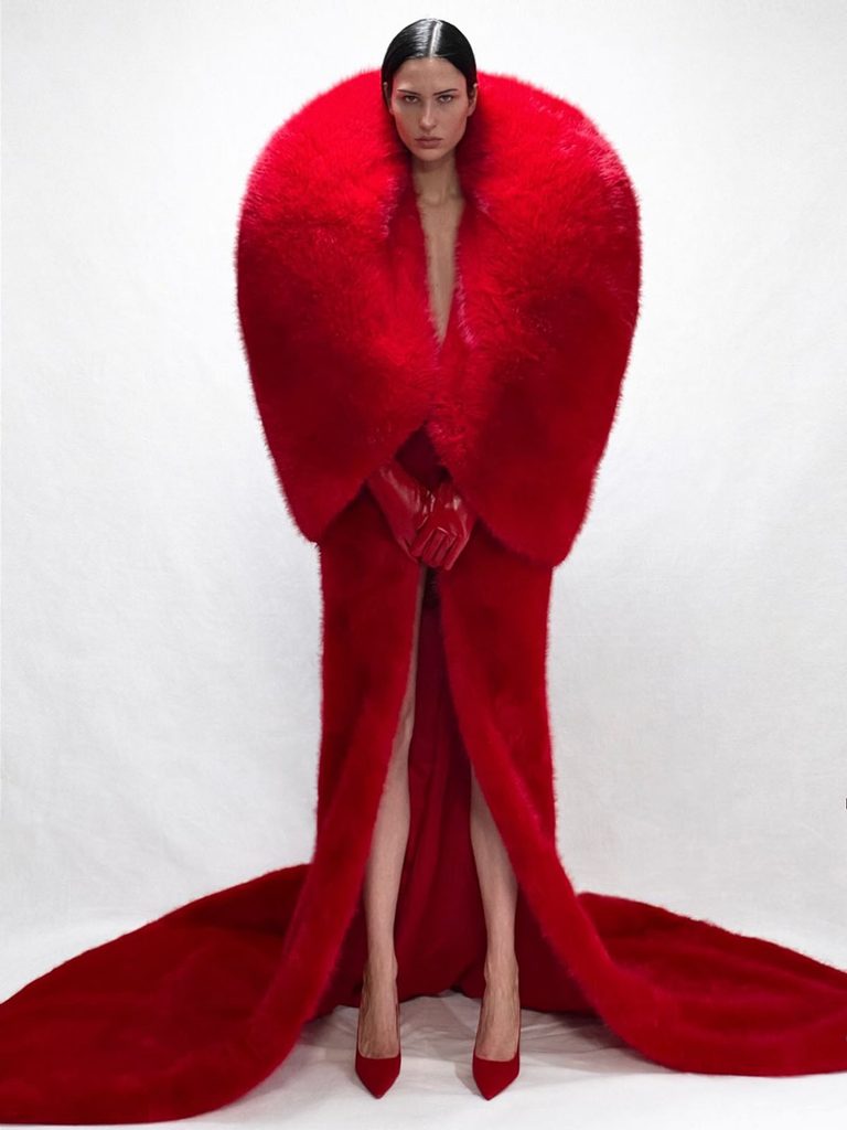 Quine Li lookbook model wearing the red faux-fur coat with the matching textured dress.