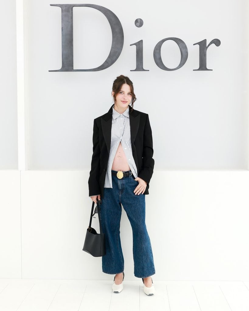 Rebecca Marder wearing Dior dark denim and tailoring at the Dior Spring 2027 show in Paris.