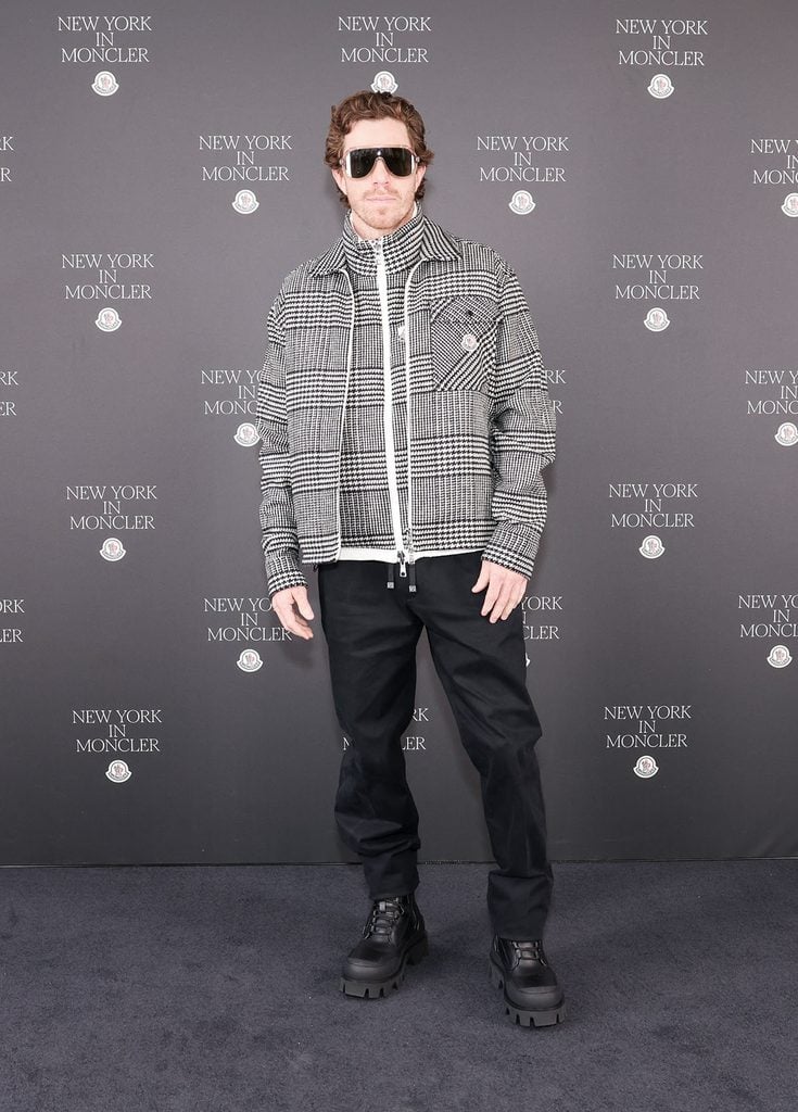 Shaun White wearing a checked Moncler jacket and zip-neck knit at the Fifth Avenue flagship opening in New York.