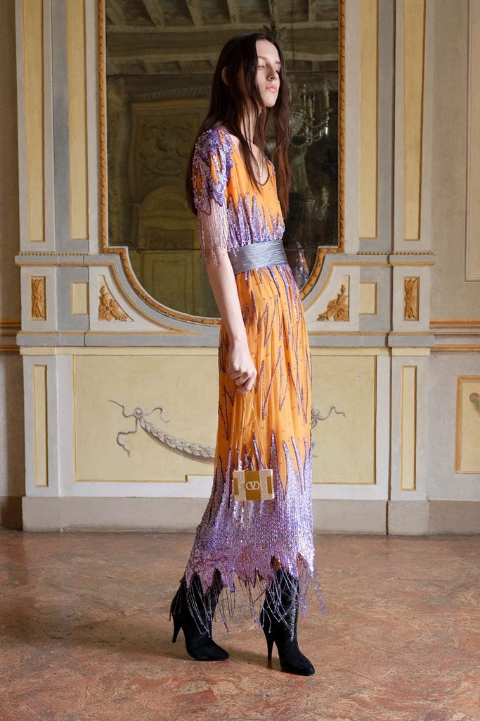 Valentino Resort 2027 orange and lavender beaded dress shown with a grey sash on the runway.