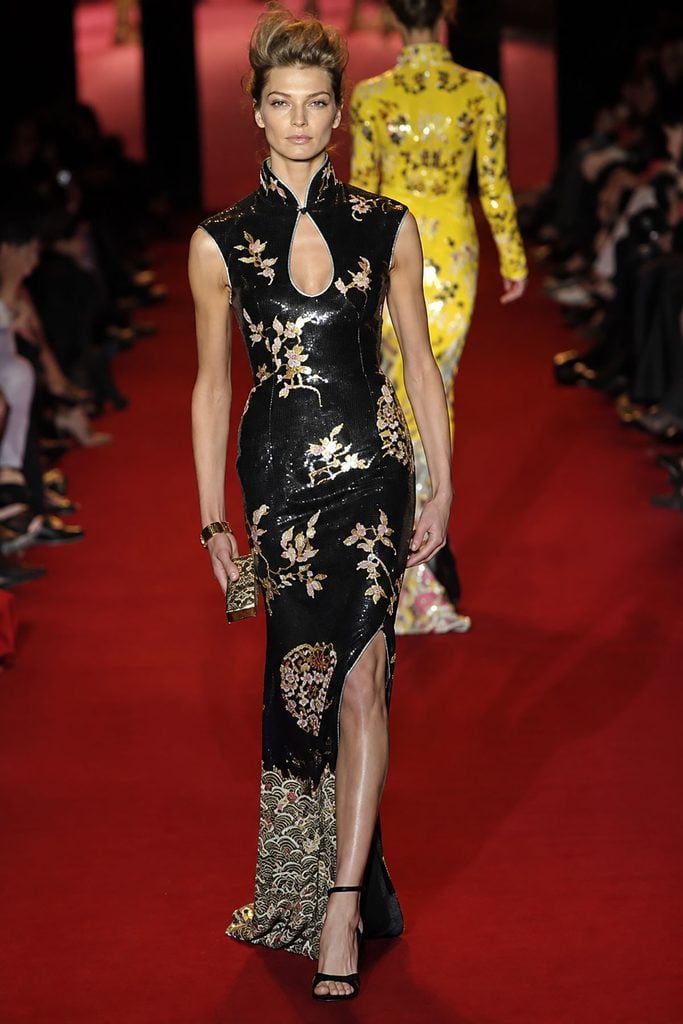 Yves Saint Laurent by Tom Ford Fall 2004 runway look featuring the black sequinned cheongsam-inspired gown.