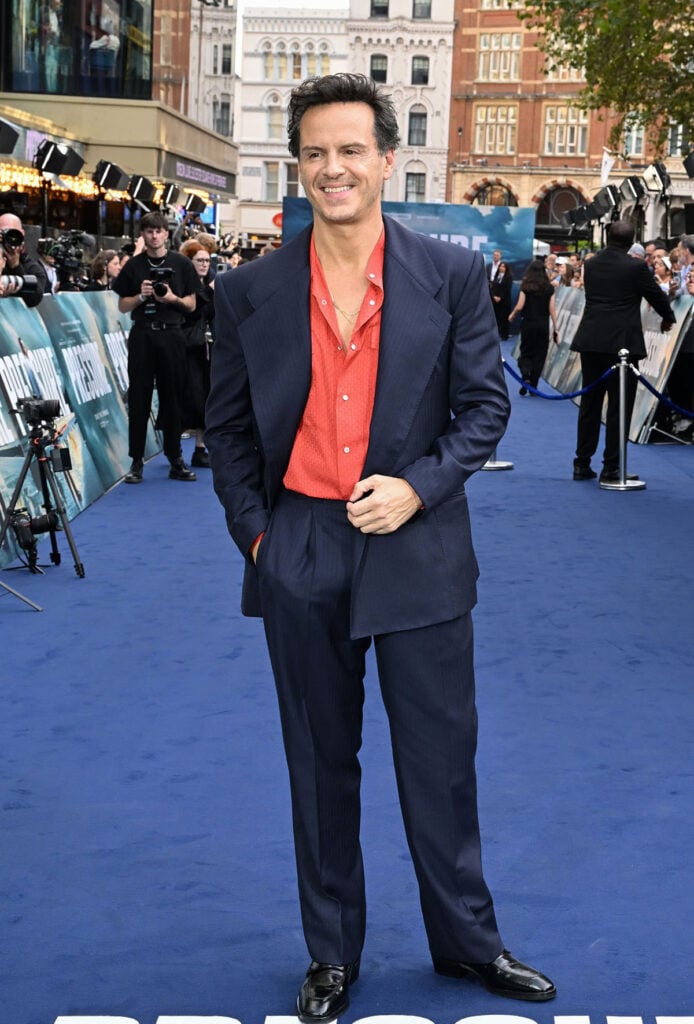 Andrew Scott wears a navy Giuliva Heritage suit with a coral-red shirt to the Pressure London premiere.