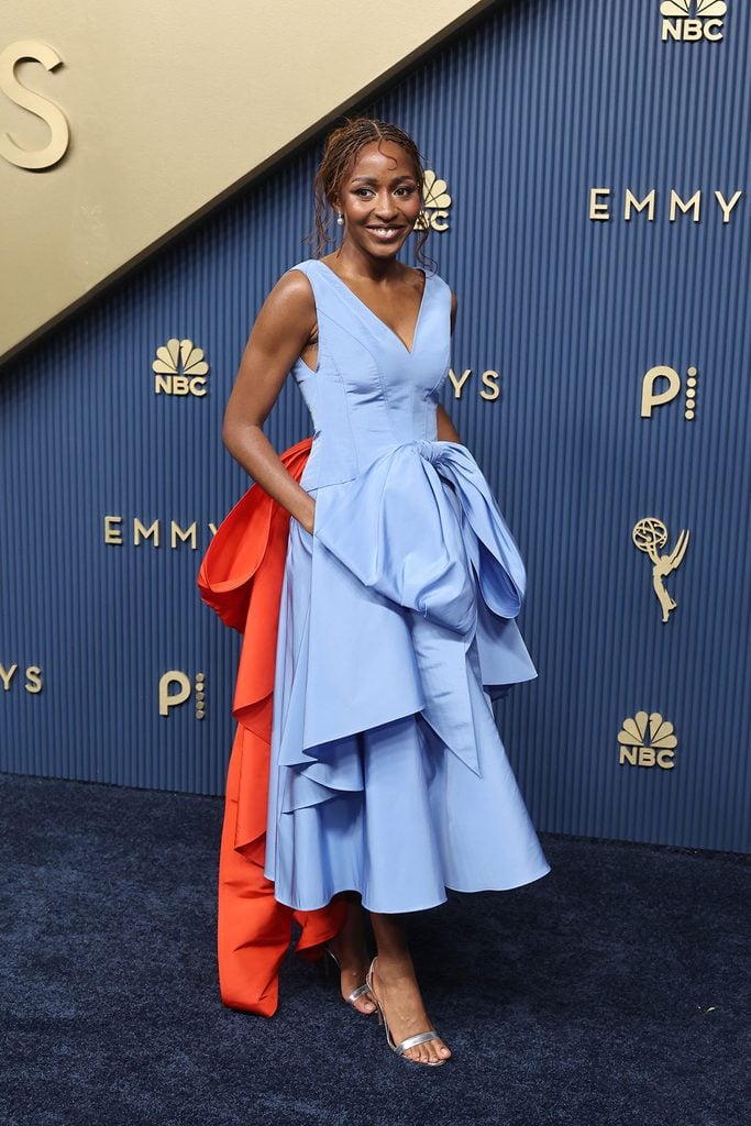 Ayo Edebiri wearing a custom blue Chanel dress with a red bow at the 2026 Emmy Awards.
