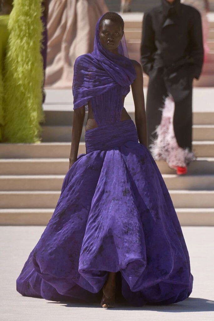 A model wears the purple sculpted Balenciaga Fall 2026 Haute Couture gown on the runway.