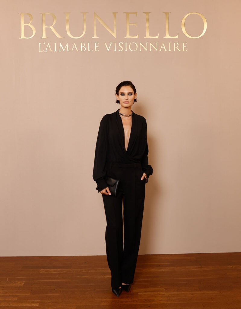 Bianca Balti wears an all-black Brunello Cucinelli look with a plunging blouse at the brand’s Paris boutique celebration.